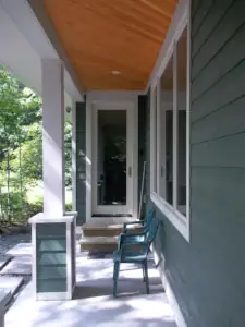 The entry door benefits from the overhanging upper storey which creates a covered entry as a byproduct.